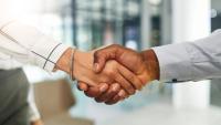 Two coworkers shaking hands.
